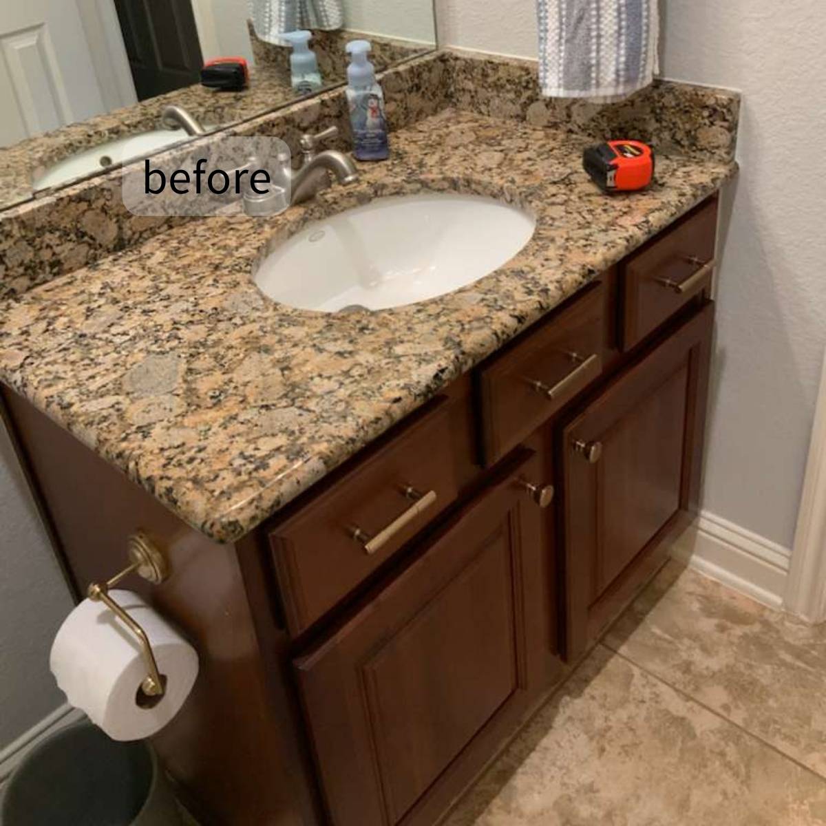 Outdated Austin bathroom with dark cabinets and countertop