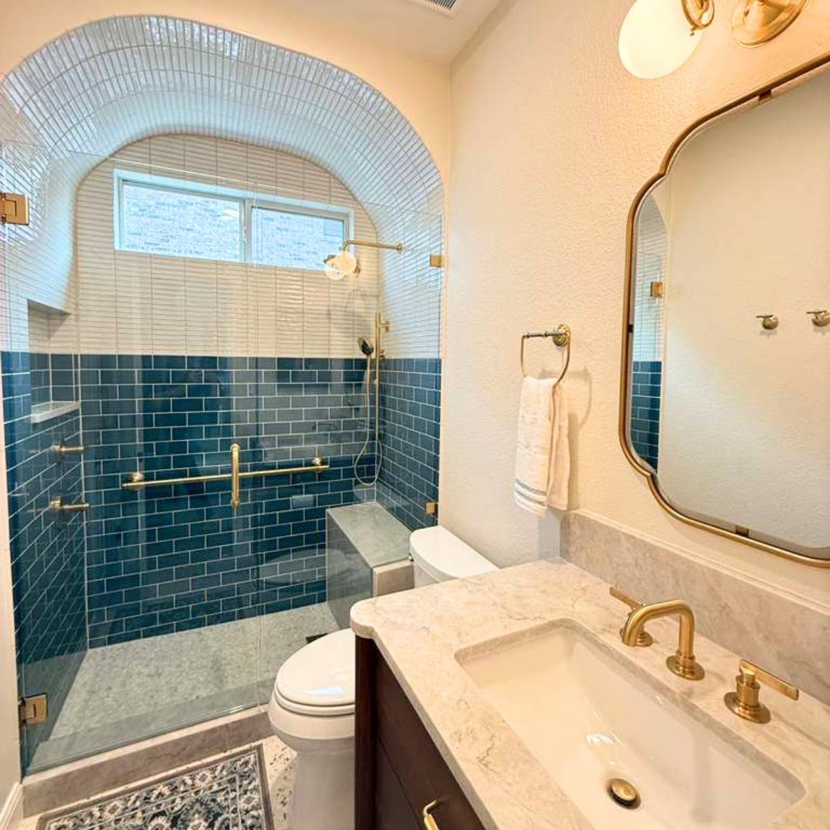 After: Luxury Austin bathroom transformation - beautiful custom tile arched shower and new fixtures