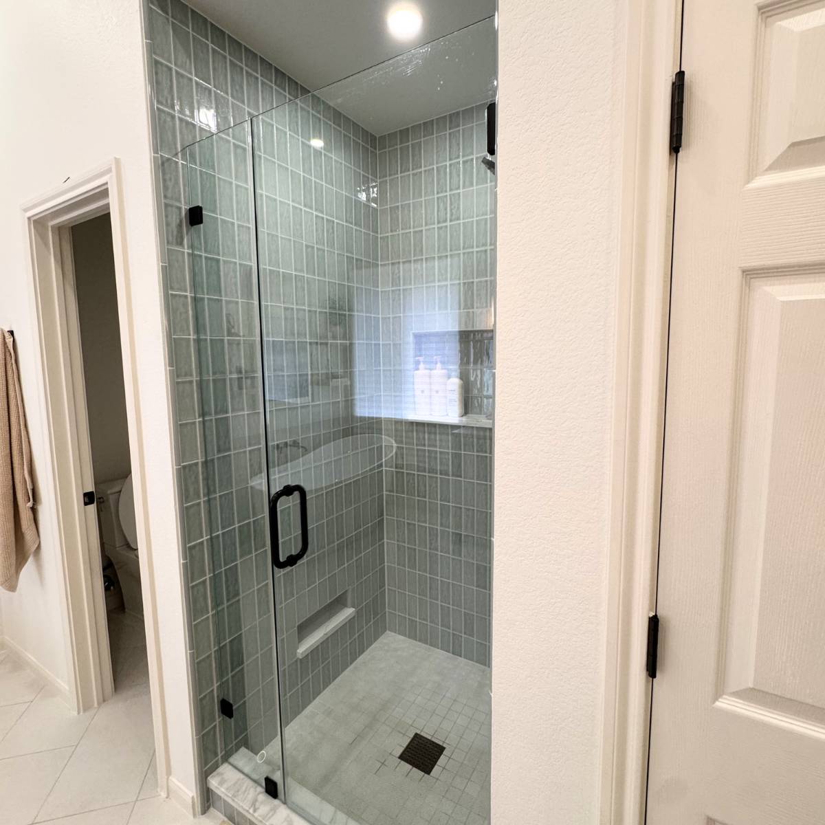 Luxury primary bathroom remodel in Cedar Park, TX featuring a frameless glass walk-in shower, and large-format porcelain tile by ATX Custom Remodel.