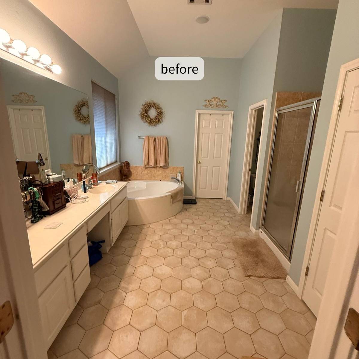 Before photo of a dated primary bathroom with beige ceramic tile and chrome fixtures  & outdated tub & shower before a luxury bathroom remodel in Cedar Park, TX by ATX Custom Remodel.