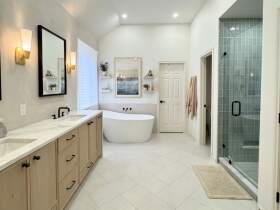 Austin primary bathroom remodel with custom cabinetry, luxury tile and freestanding tub