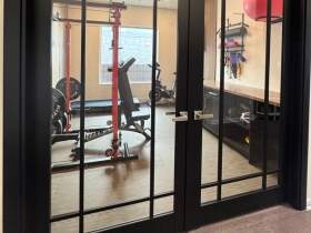Austin custom home gym remodel with built-in storage and fitness space