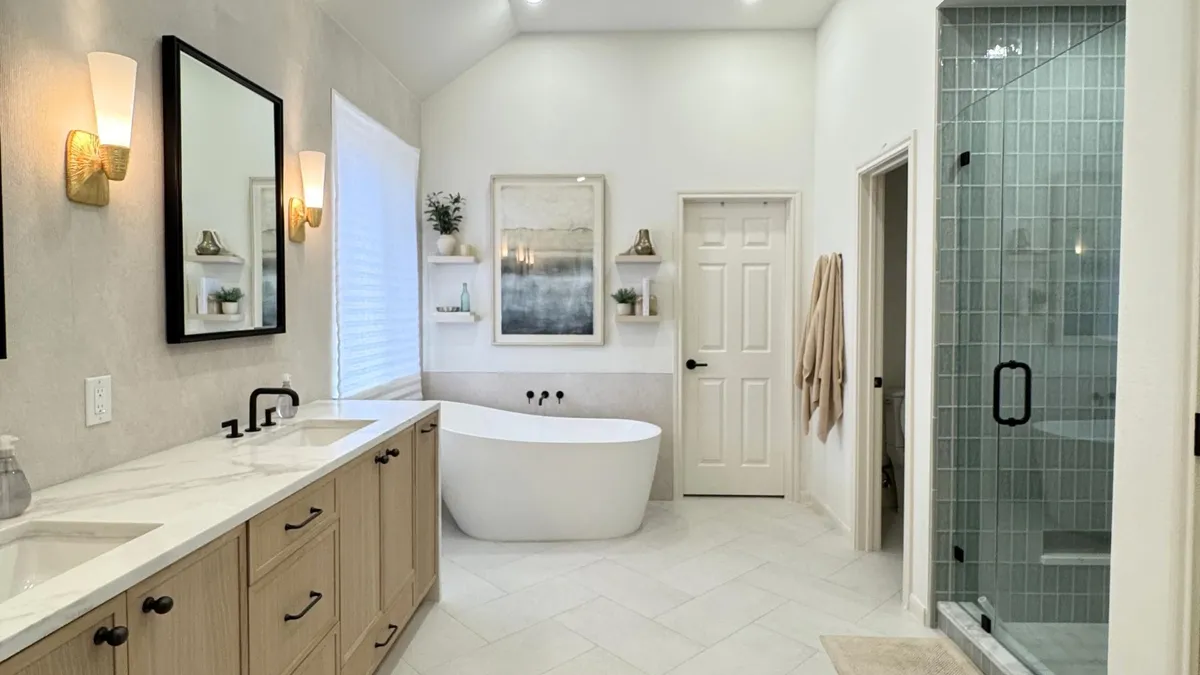 Austin primary bathroom remodel with custom cabinetry, luxury tile and freestanding tub
