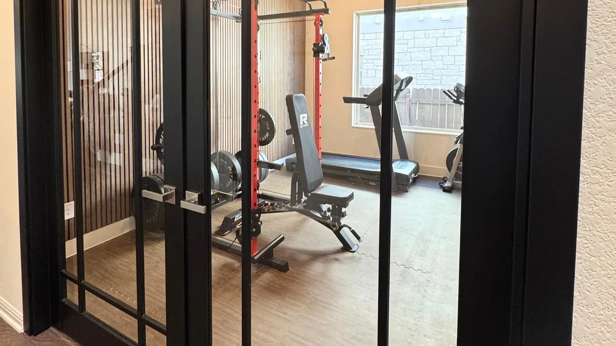 Austin custom home gym remodel with built-in storage and fitness space