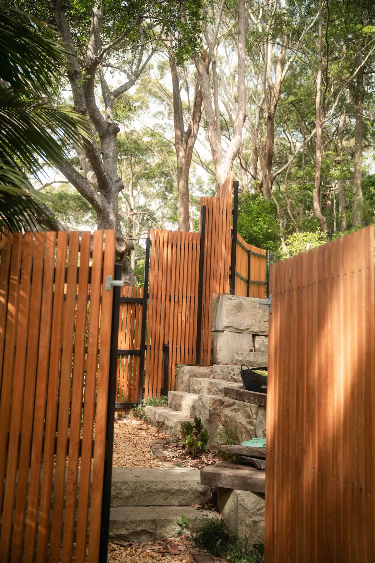 Hardwood batten gates opening onto sandstone steps
