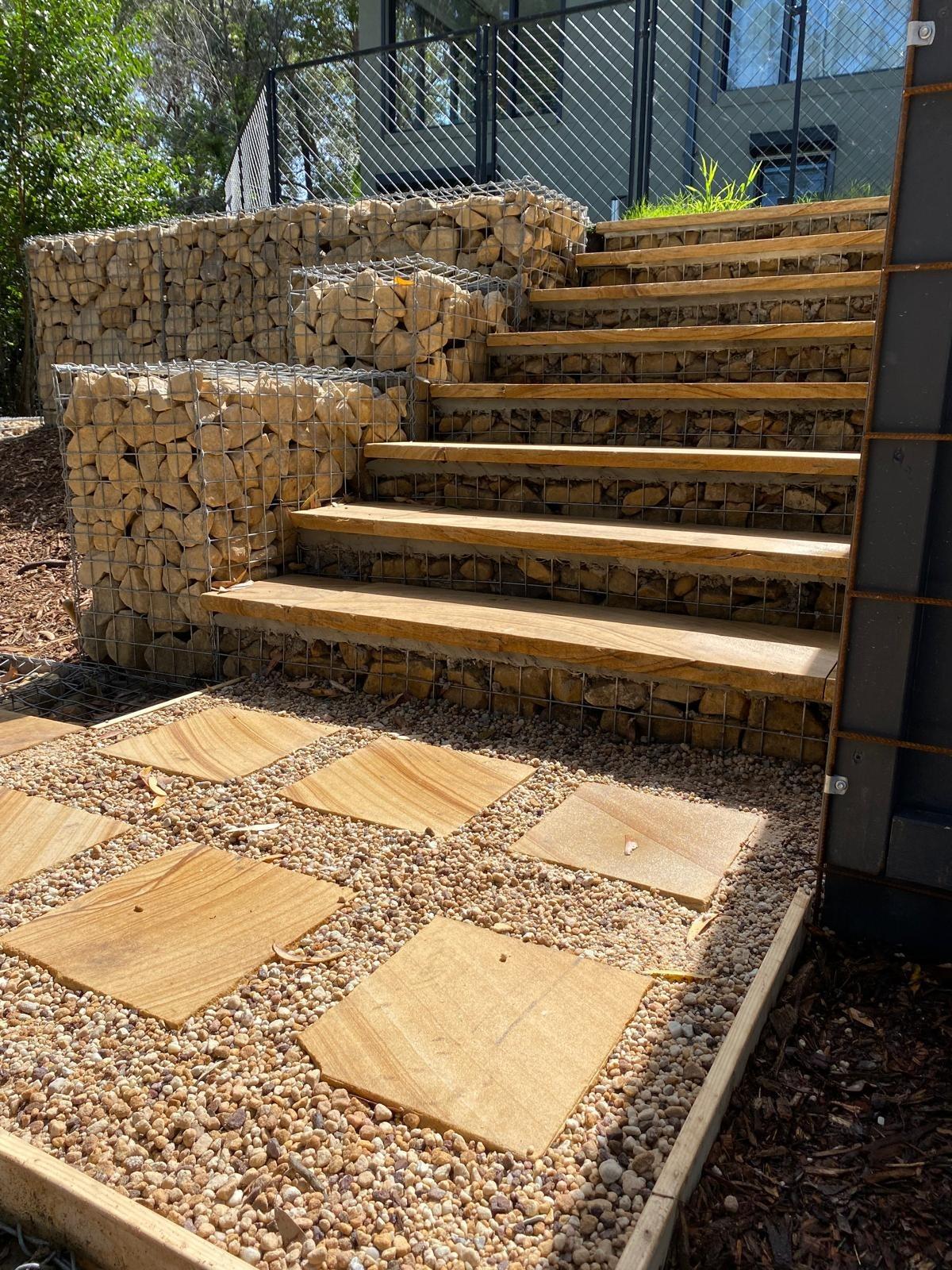 Sandstone treads between gabion walls with stepping-stone pavers