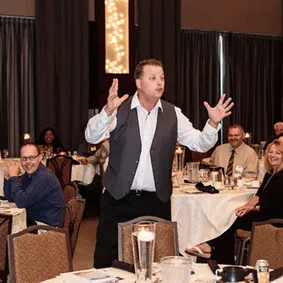 Motivational speaker wearing a vest in deep thought
