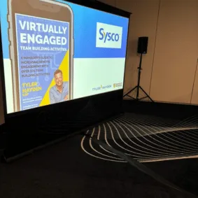 motivational speaker Slide deck projected on screen for training event about remote work