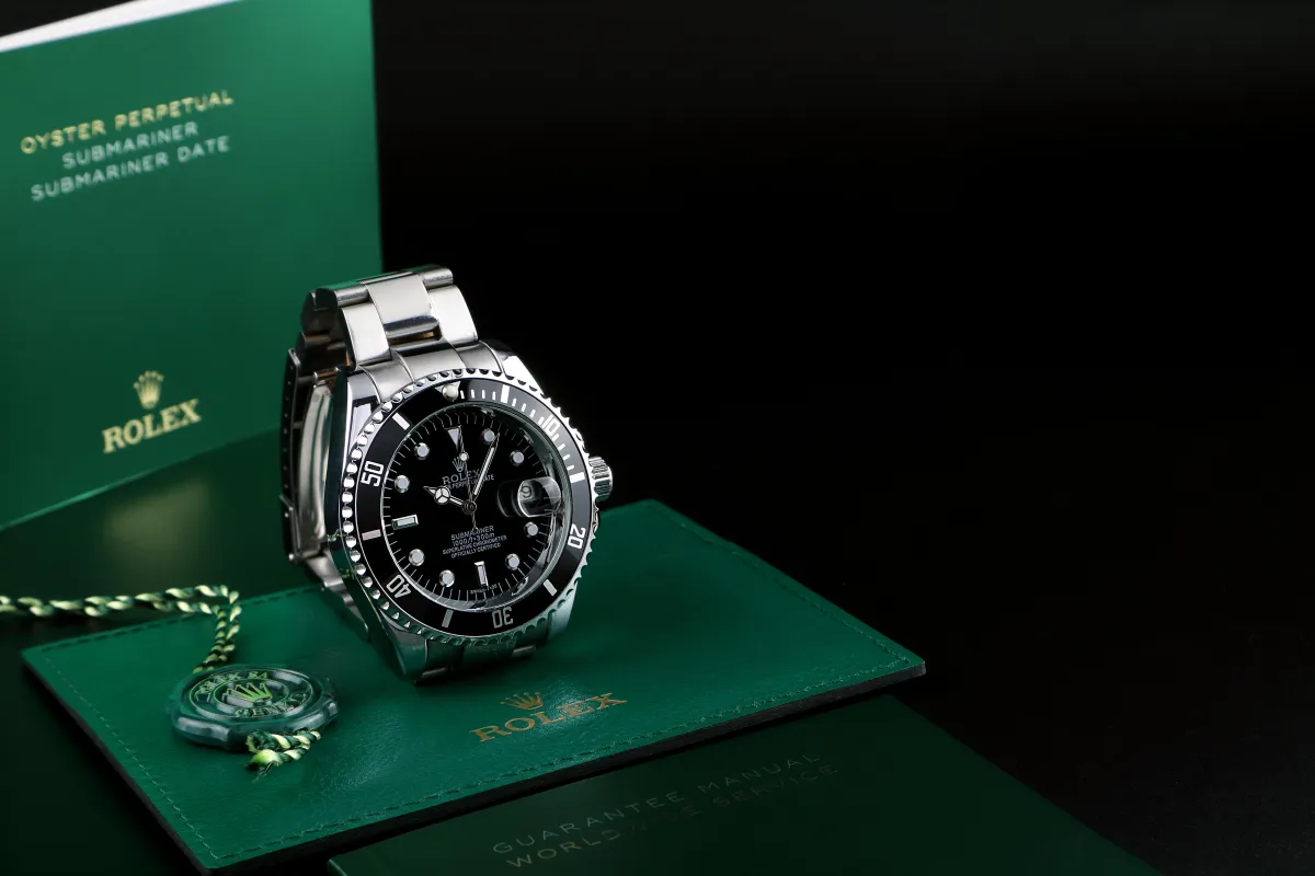 person wearing round gold-colored analog watch with link band