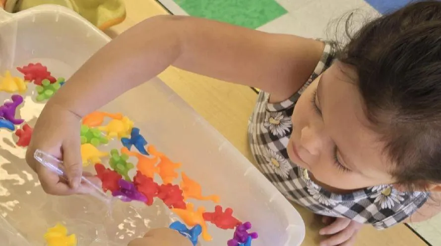 Girl watches a lesson about the alphabet on a laptop
