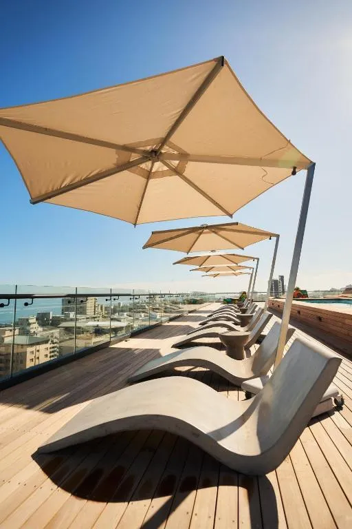 Luxury studio suite at Little Luxe Heaven featuring a balcony and full kitchen for an exquisite Cape Town stay.