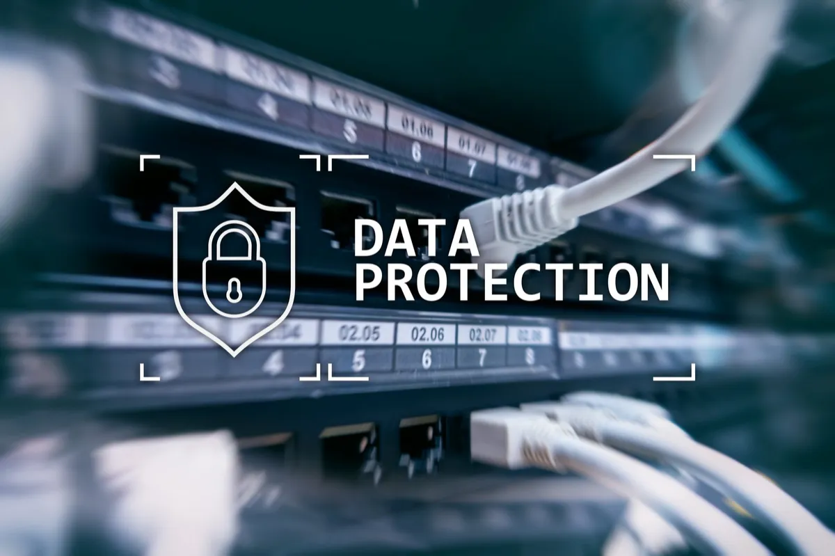 Server patch panel with network cables and a shield-and-padlock “data protection” icon representing layered cybersecurity defenses