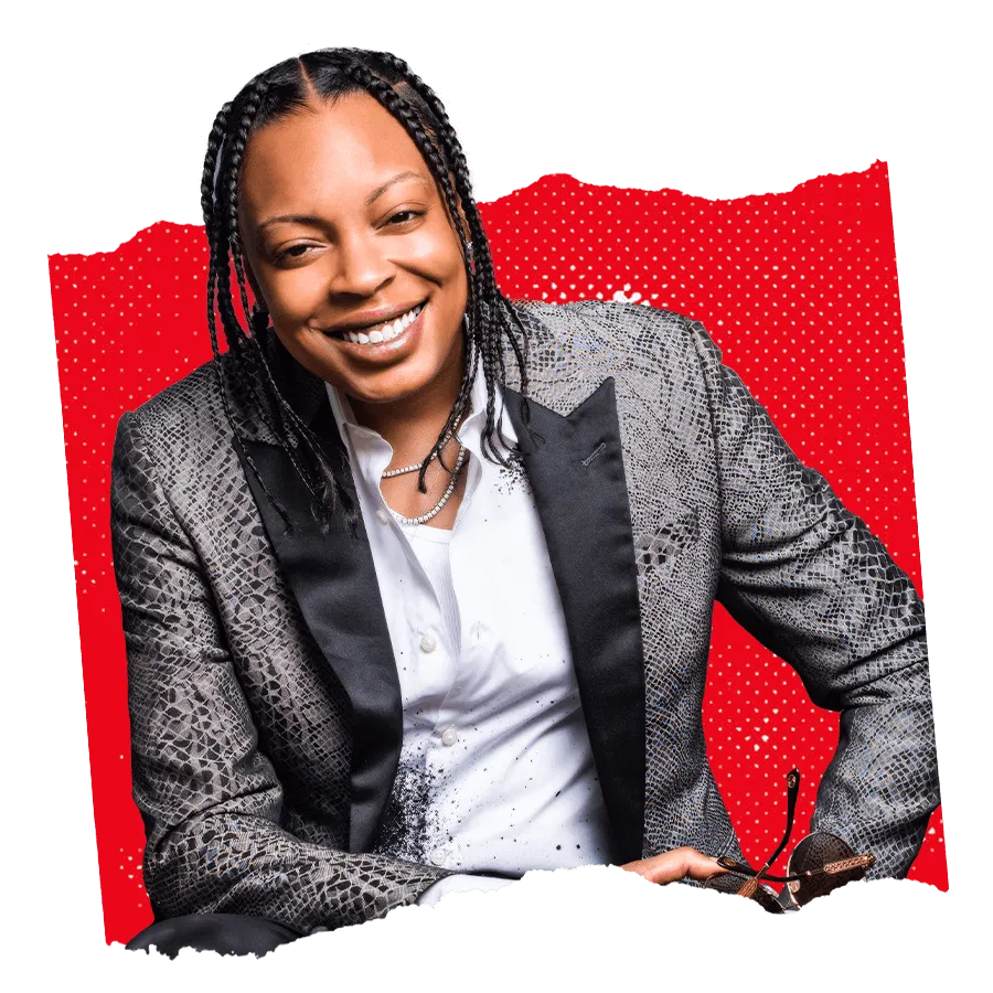 Mychel “Snoop” Dillard, smiling, in a sleek snakeskin suit with a red background; the inspiring face of the successful Landlord Method.