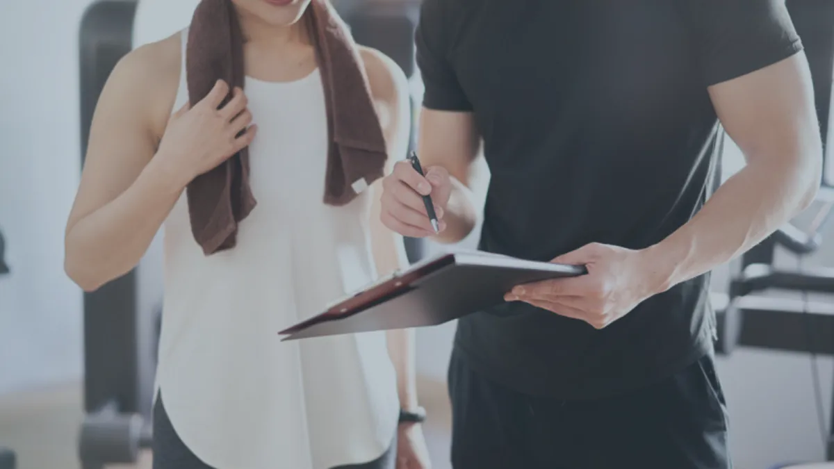 Personal trainer coaching a member