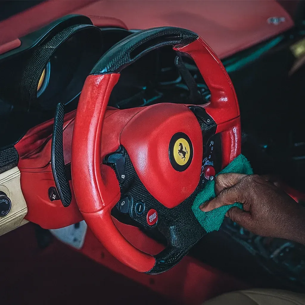 Detailer cleaning interior of a car