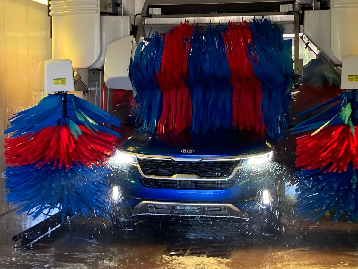 Blue SUV going through automatic car wash