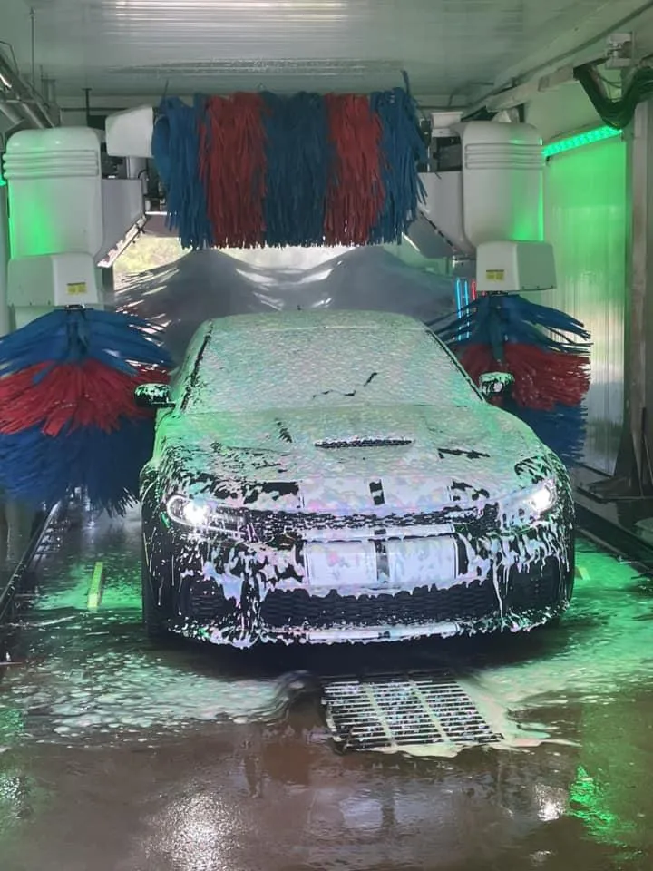 A muscle car going through a car wash at Defense Auto Wash in Langley AFB