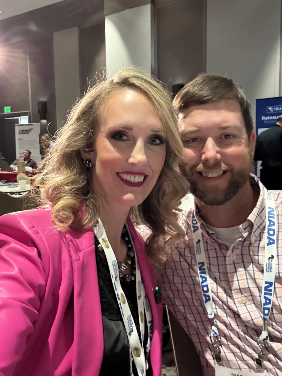 Head-and-shoulders portrait of a smiling middle-aged woman in natural light, neutral background, 1:1 composition.