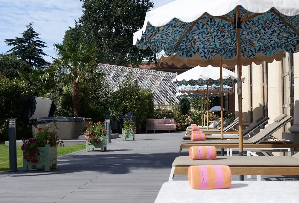 green grass field near green trees under white sky during daytime