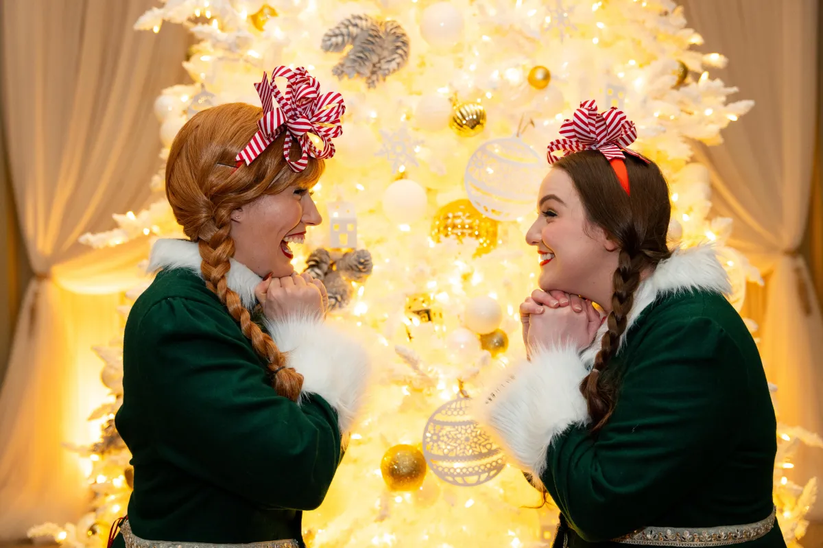 2 models pose with a Christmas gift at the Vancouver Clubs Christmas celebration event. Photo taken by events photographer, Ollie Kirwan.