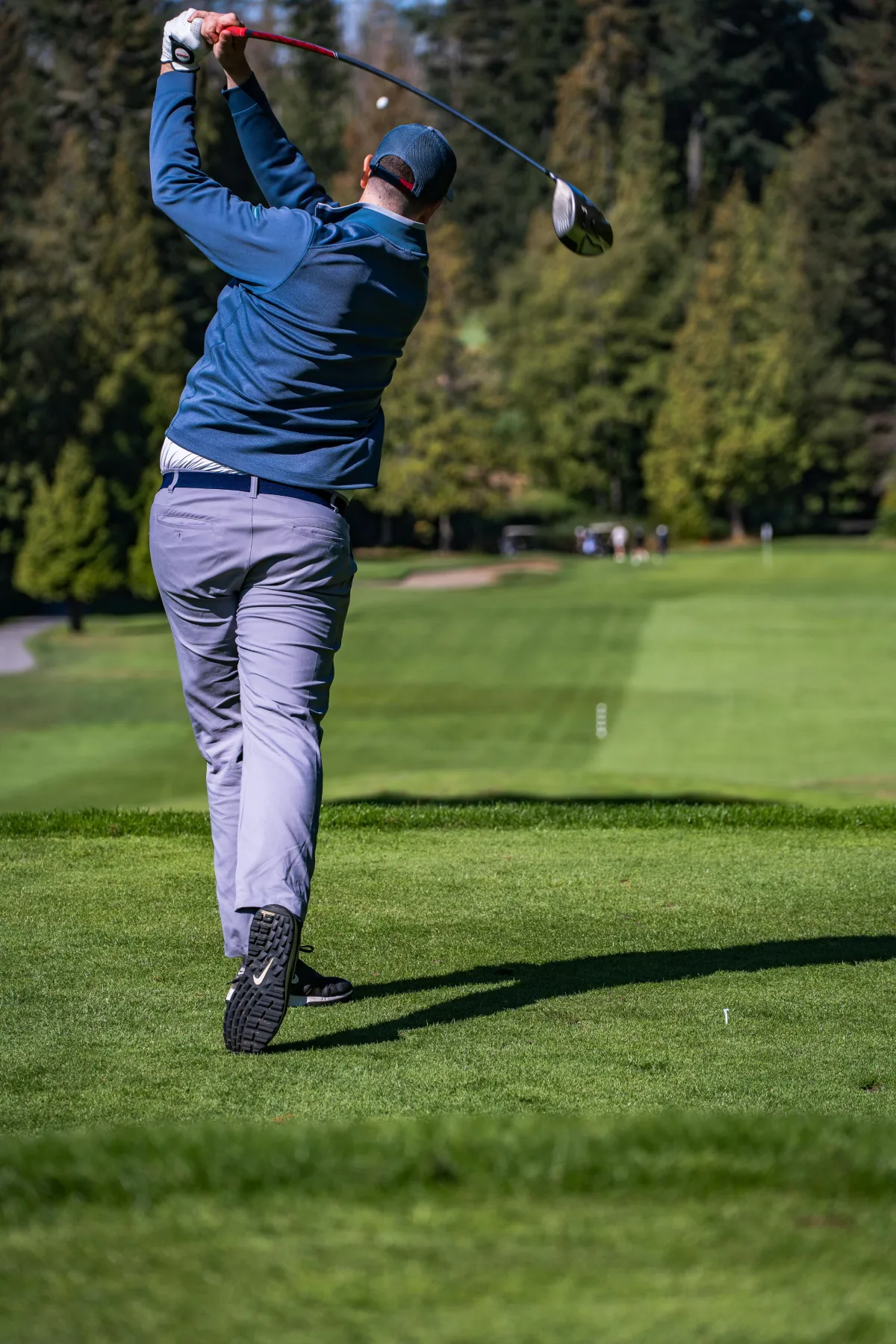 A golfer hits his drive down the fairway at a golf event in Vancouver.