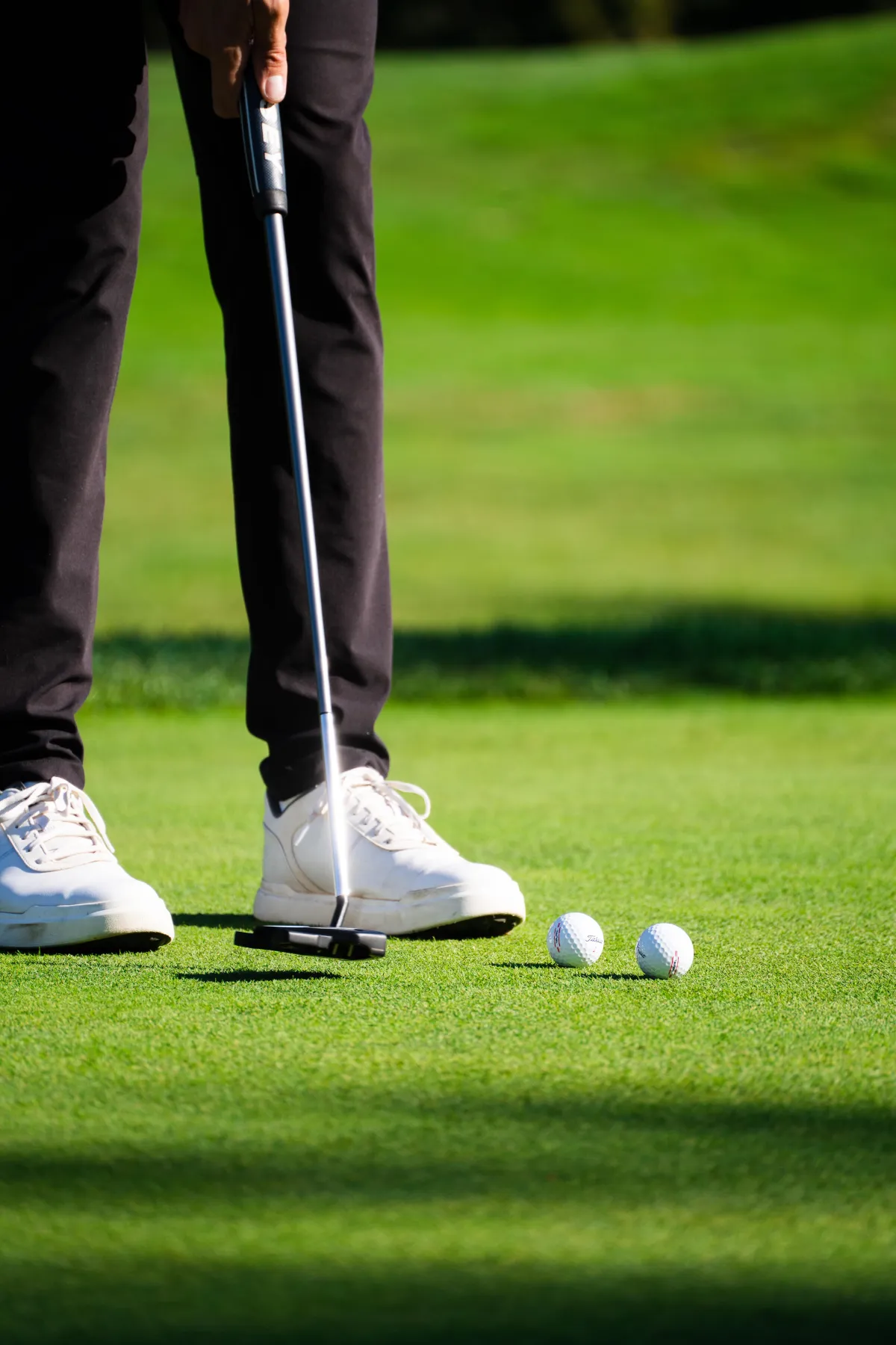 A golfer practices his putting on the green at a charity golf event in Vancouver. 