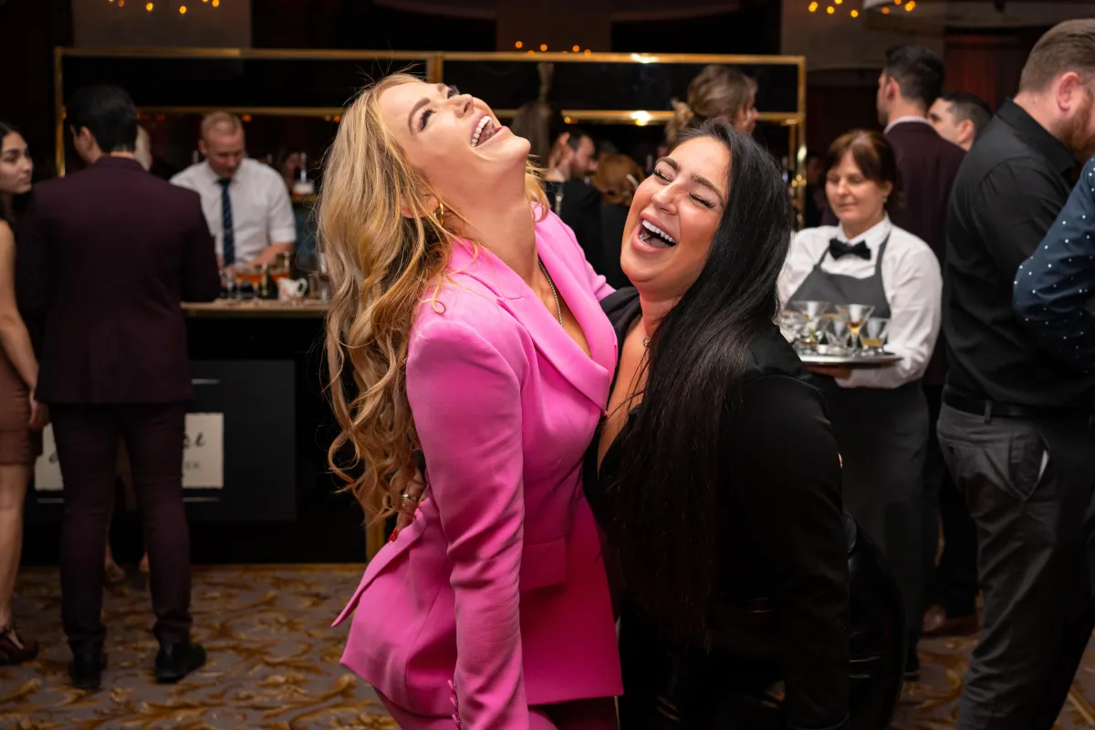 2 ladies laugh together at an event in the Vancouver Club