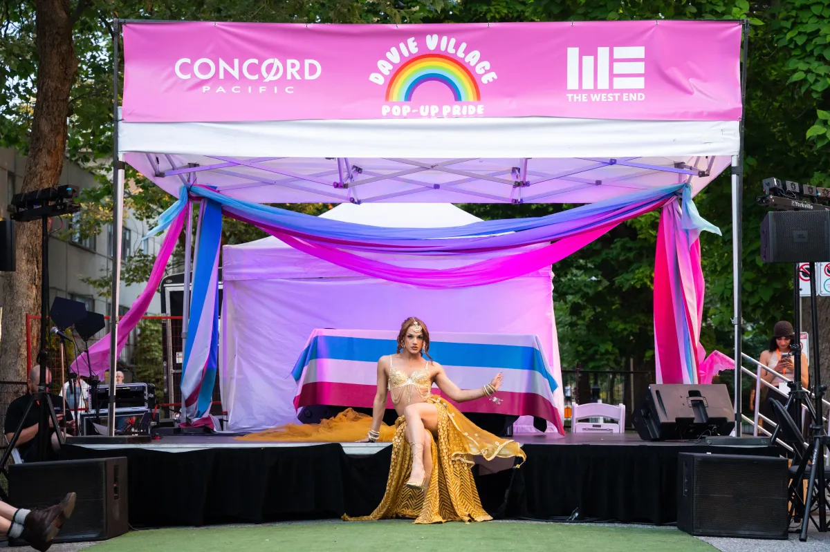 A performer poses in front of the stage at a Vancouver event