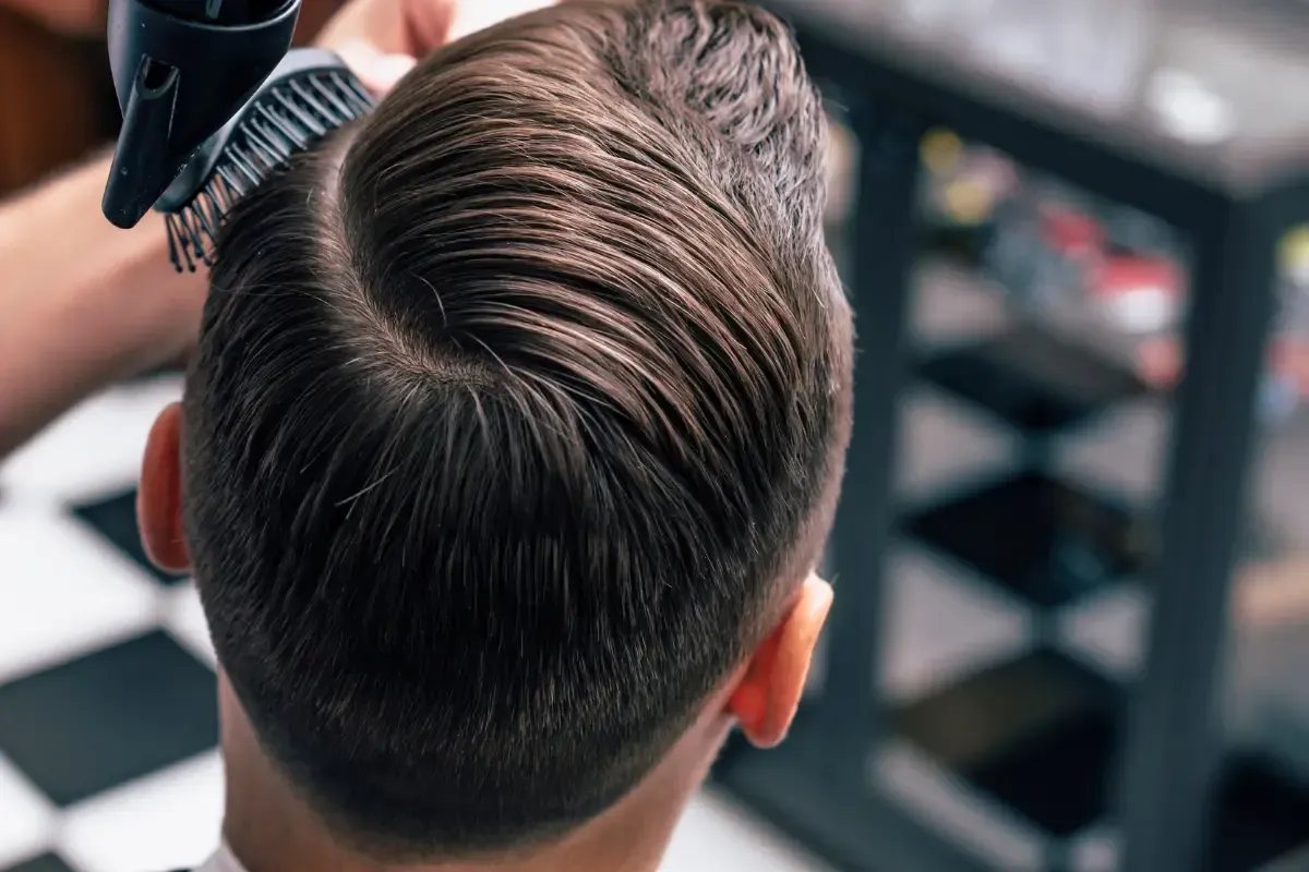 Back view of a client getting a blow-dry and comb-over styling at Scuttlebutt Barbershop near Rye, NH.