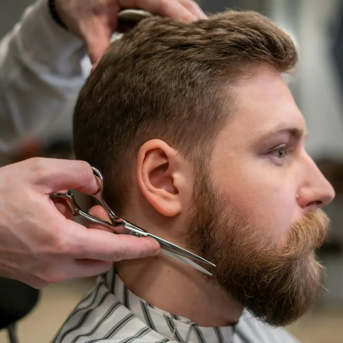Barber giving a precise beard and neckline trim to a client at Scuttlebutt Barbershop in Portsmouth, NH