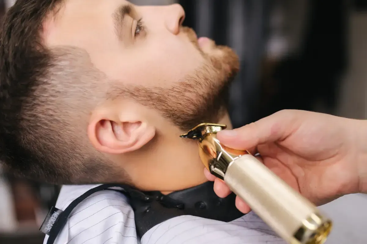 Beard lineup with gold trimmer at Scuttlebutt Barbershop near Hampton, NH