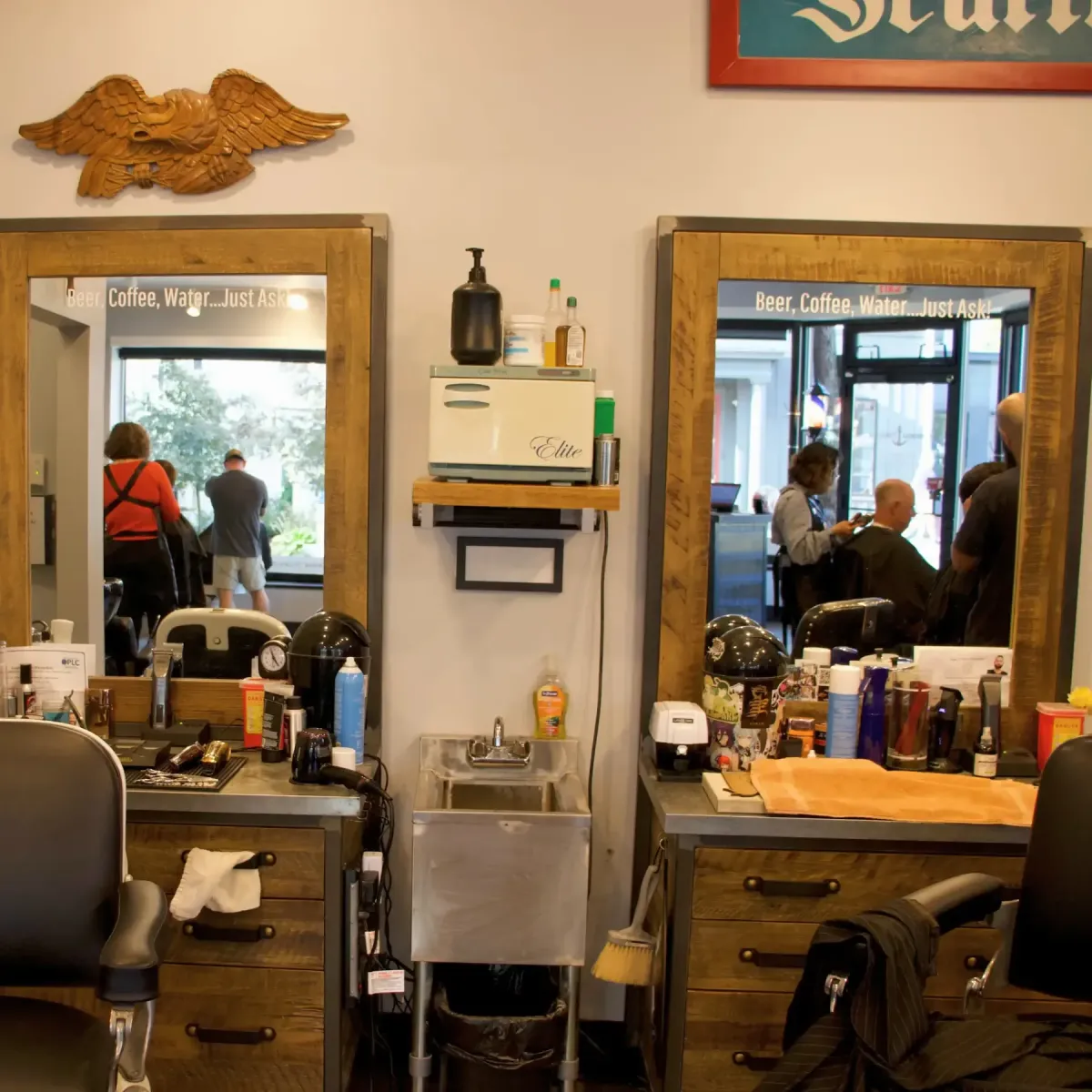 Interior of Scuttlebutt Barbershop in Portsmouth NH showing two barber stations with mirrors, chairs, and grooming tools