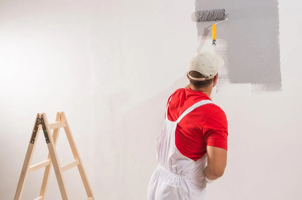Man painting the interior walls of a home