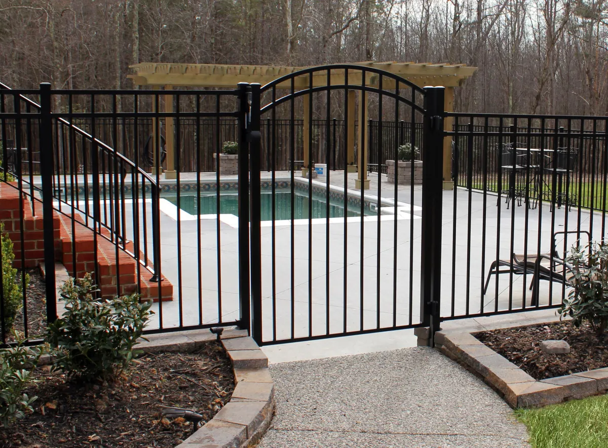 Corrugated fence gate for a pool enclosure