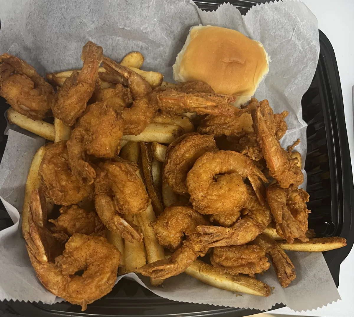 Fried Shrimp in a basket atop of fries