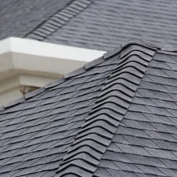 Man attaching flashing to a residential chimney rooftop