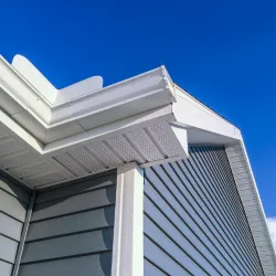 Man attaching flashing to a residential chimney rooftop