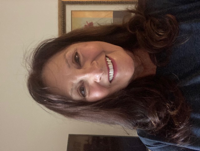 short-haired black cat besides brown wooden table