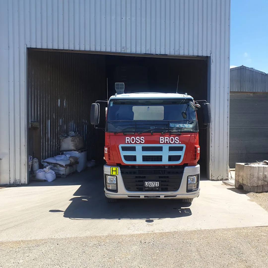Fertiliser delivery truck unloading at farm site