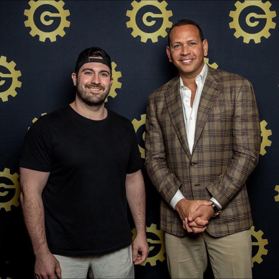 woman in black tank top and black skirt standing on white wall