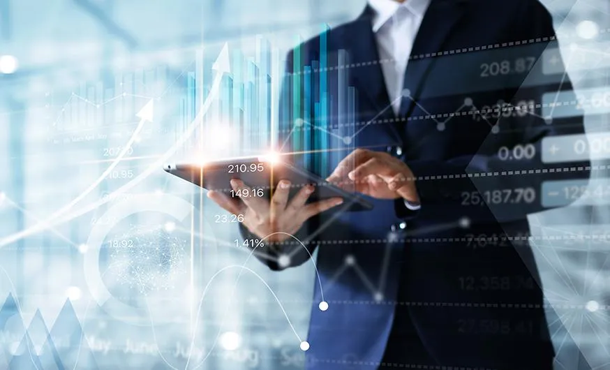 Business professional in a suit using a digital tablet with financial charts, stock market data, and analytics overlay. Abstract technology and data visualization elements highlight concepts of financial growth, investment, and digital transformation in business strategy.