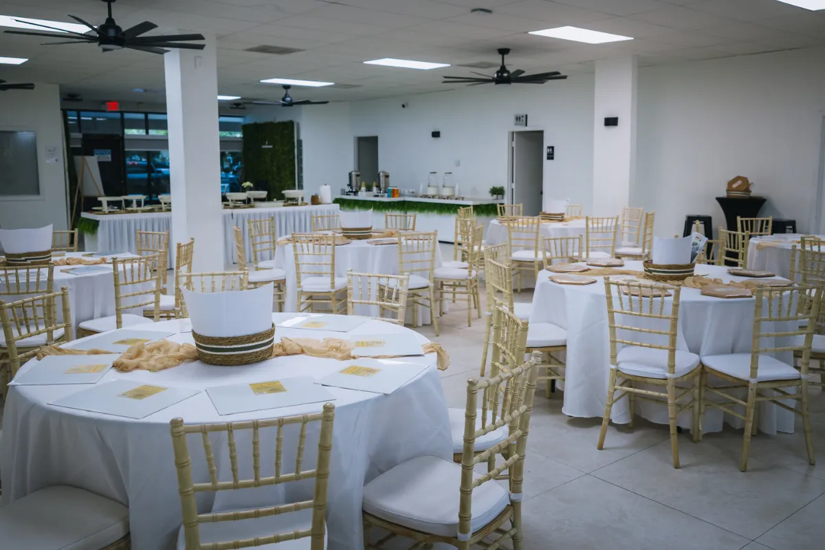 Versatile event space in Lauderdale Lakes FL with round tables and chiavari chairs set for brunch, workshop, or private event
