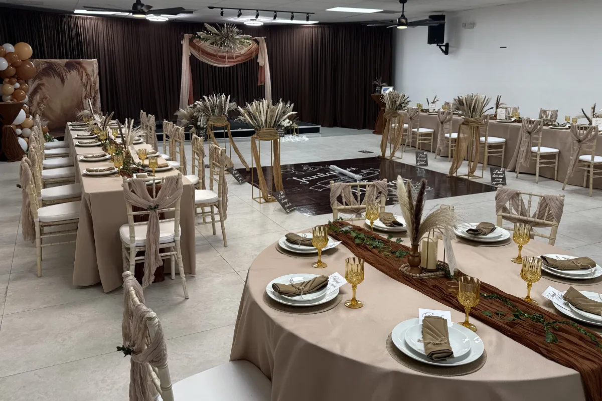Elegant wedding venue setup at Born On Purpose Hub in Lauderdale Lakes, FL with neutral-toned tablescapes, chiavari chairs, custom dance floor, ceremony backdrop, and spacious indoor event space for weddings, receptions, bridal showers, and special events.