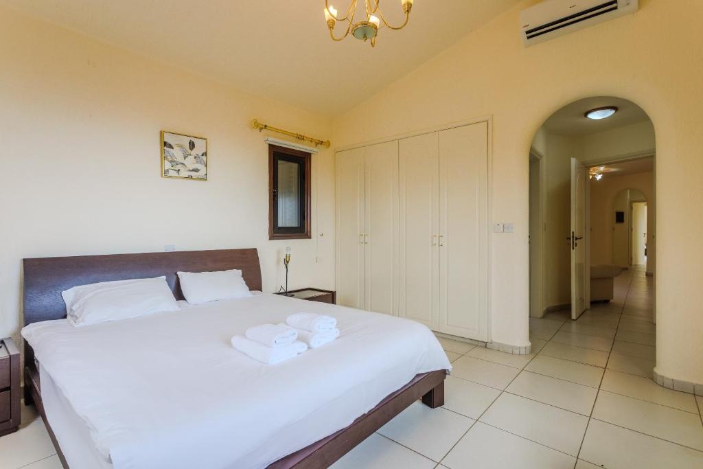 Serene and minimalist private guest bedroom at our boutique Paphos villa, designed for deep rest and somatic safety.