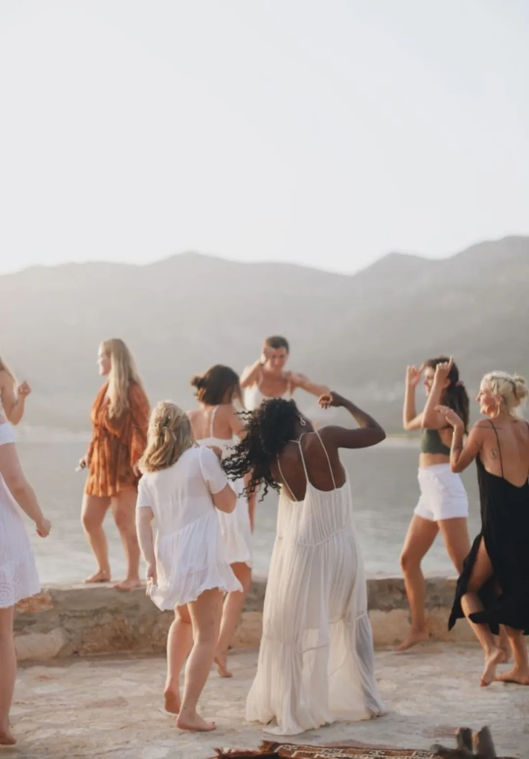 Women expressing themselves through ecstatic dance under the Mediterranean sun, reclaiming their body’s natural rhythm.