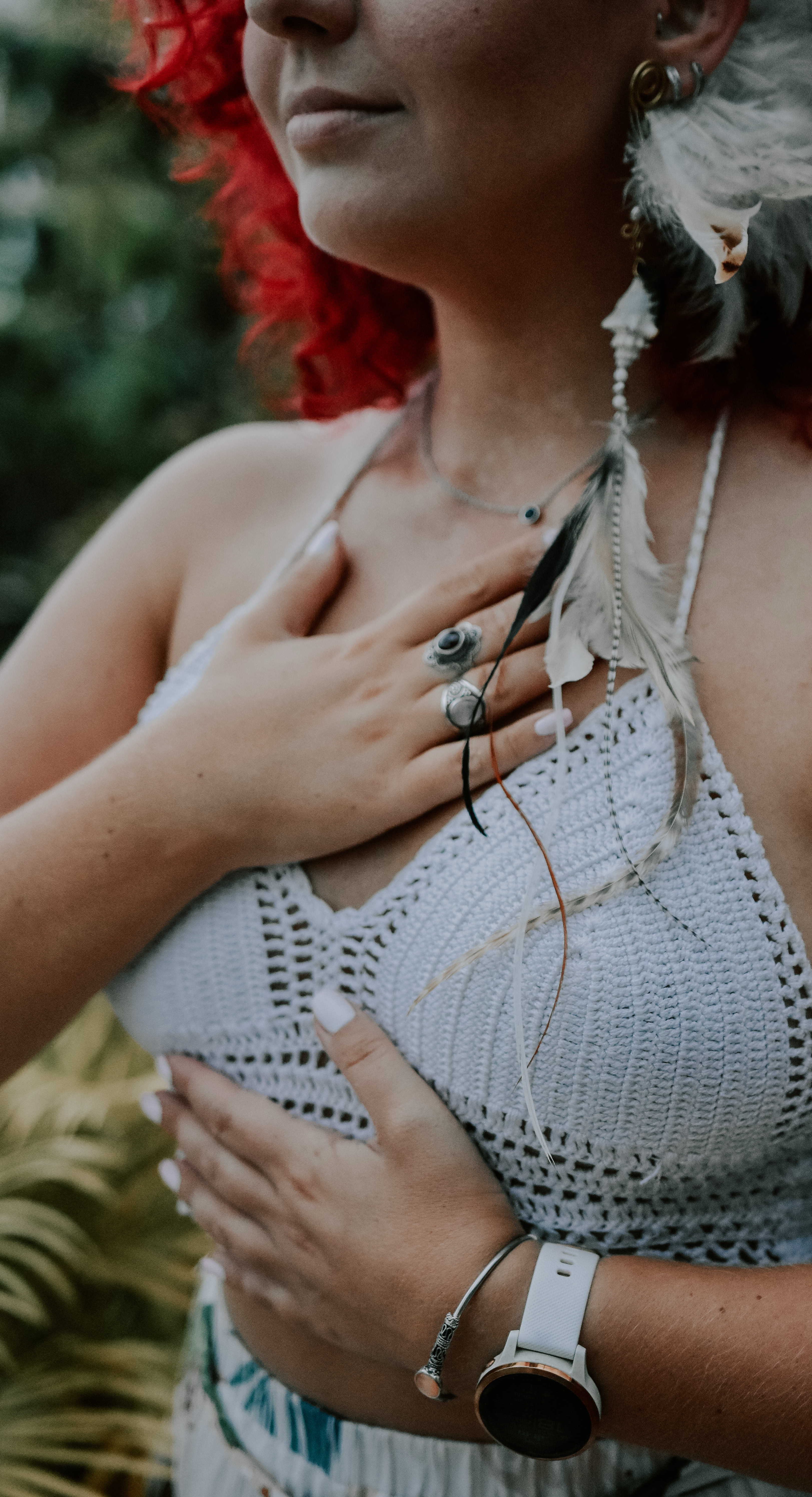 A close-up of Gerly with a hand placed gently over the heart center, representing somatic self-attunement, compassion, and inner child healing.