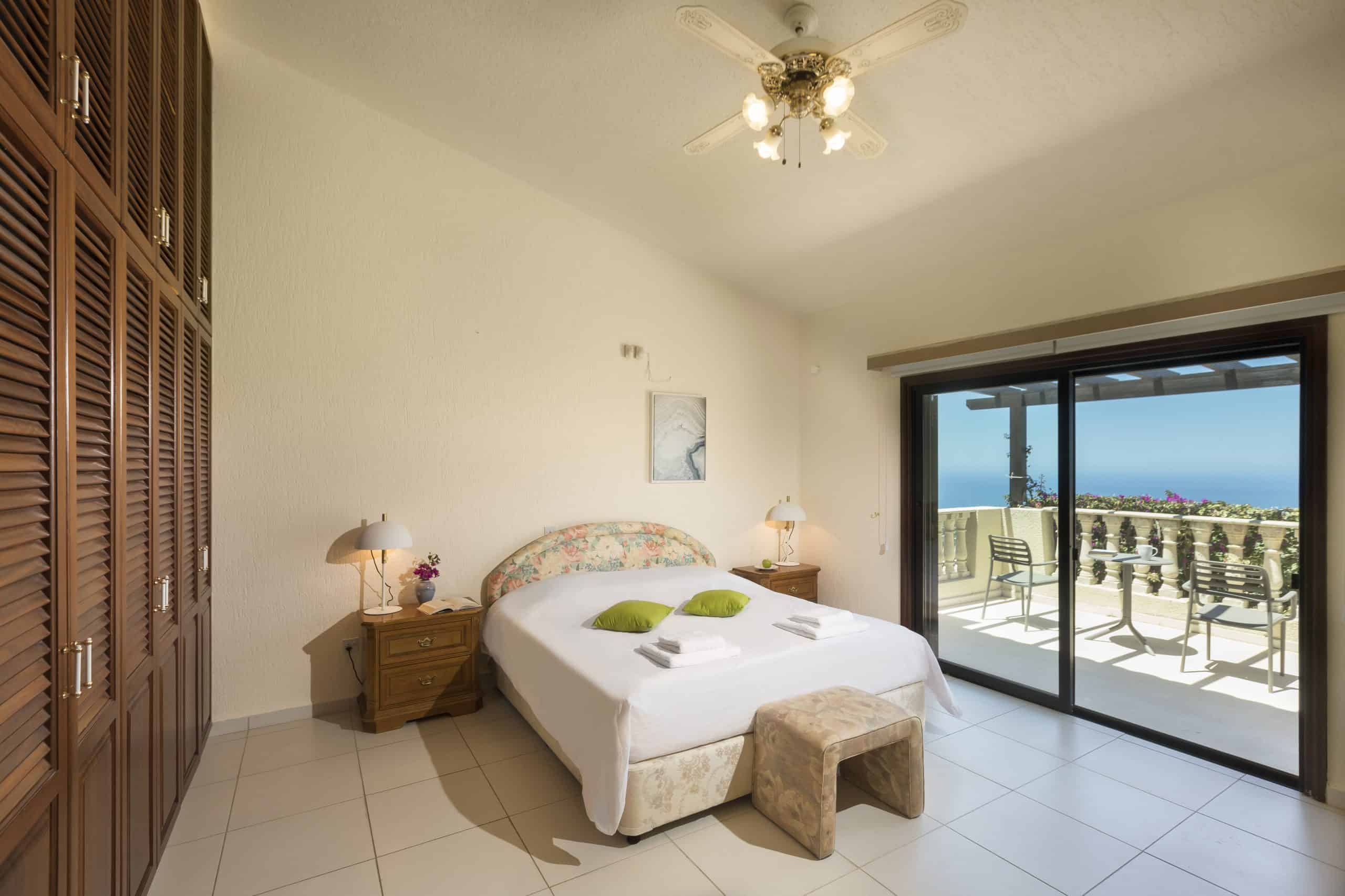 Serene and minimalist private guest bedroom at our boutique Paphos villa, designed for deep rest and somatic safety.
