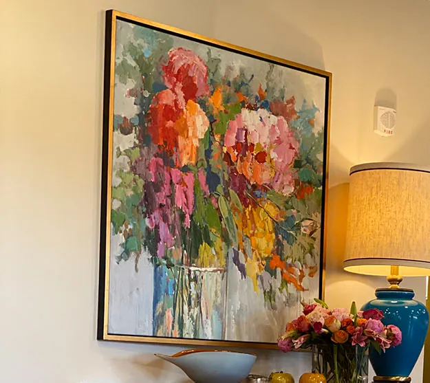 Floral still life painting with a blue lamp on a pink cabinet