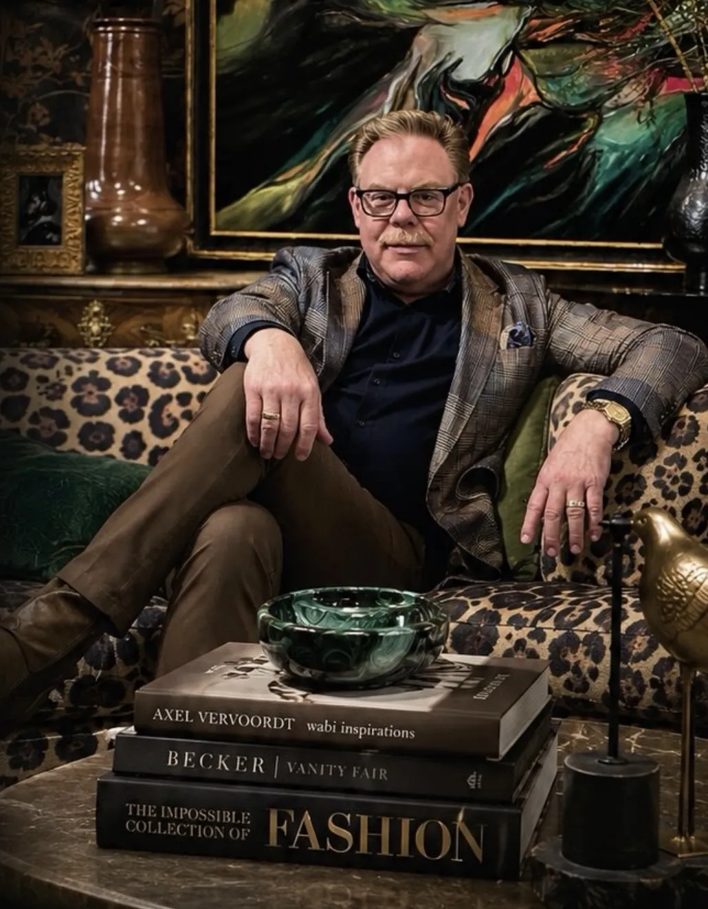 Rich Schell of Rich Schell Interiors in a richly layered room with art and design books
