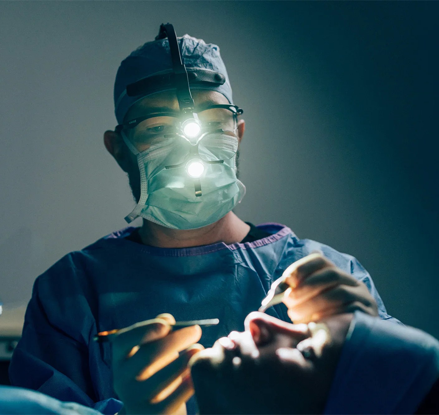 person holding clear glass bottle